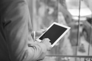 Business man looking at a tablet.
